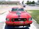 1978 Ford Mustang II - Front view of a red 1970s Ford Mustang II, likely from the mid-1970s, a prominent hood scoop and racing stripes.