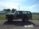 1979 Ford Bronco - A camouflaged Ford Bronco with "US ARMY" painted on its side is parked outdoors.