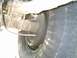 1984 Ford Bronco - This image shows the rear suspension and tire of a vehicle, focusing on the brake drum and leaf springs.
