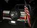1988 Ford Bronco - Rear view of a 1987 Ford Bronco showing its spare tire and an American flag.