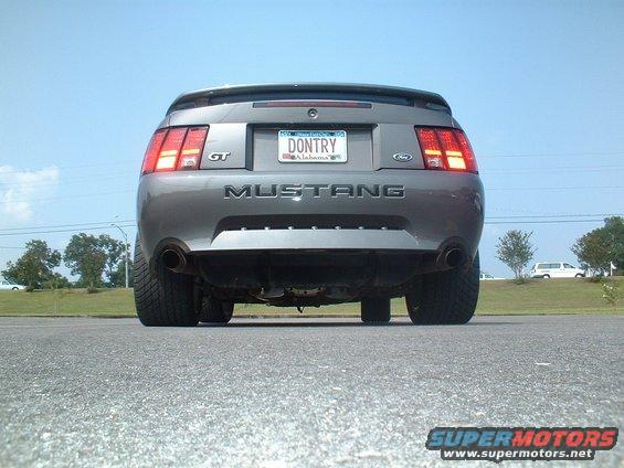 Rear view of a gray 2003 Ford Mustang GT with a custom license plate