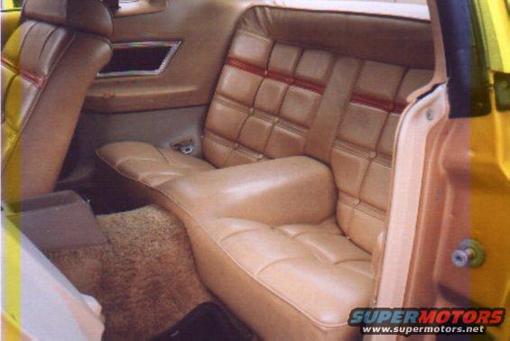 Tan vinyl interior of a 1978 Ford Mustang II, showing quilted rear seats and door panel
