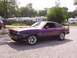 1978 Ford Mustang II - A purple 1978 Ford Mustang II coupe is parked on a gravel lot.