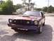1978 Ford Mustang II - A 1978 Ford Mustang II with a custom iridescent paint job is parked on a gravel lot.