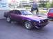 1978 Ford Mustang II - A 1978 Ford Mustang II Cobra II in a striking purple paint job sits on a car lot.