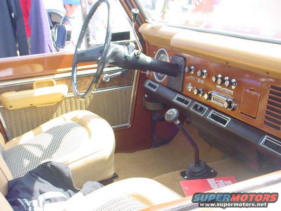 1979 Ford Bronco interior with woodgrain dash and plaid seats