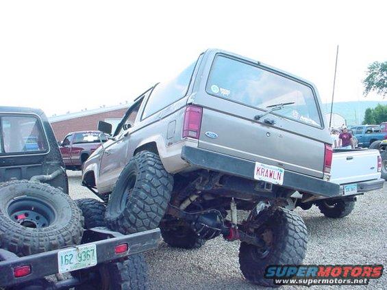 Rear view of a lifted 1979 Ford Bronco with large tires and a custom license plate