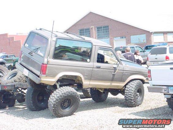 Lifted brown SUV with large tires, side view