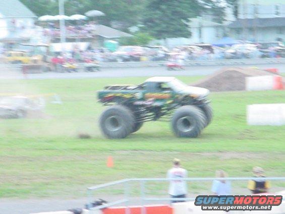 Monster truck with large tires driving on grass