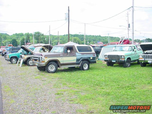 Brown and tan Ford Bronco parked in a line of vehicles