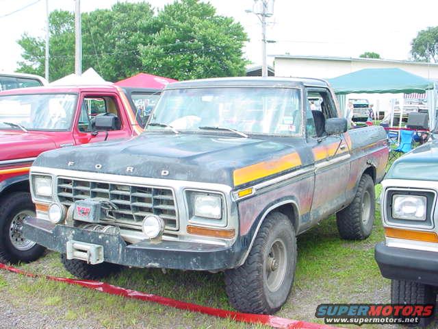 1979 Ford Bronco, front grille with winch, weathered paint, parked on grass