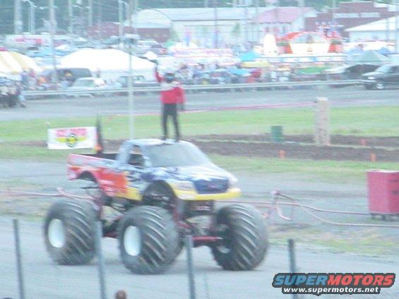 Monster truck with a person standing on its roof