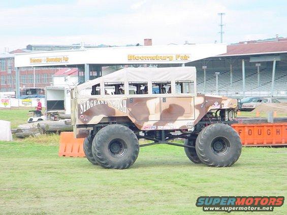 Monster truck with camouflage paint and 'SERGEANT SMASH' text, side view