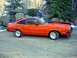 1978 Ford Mustang II - This 1978 Ford Mustang II coupe features a bright orange paint job with black racing stripes and custom wheels.