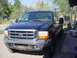 1999 Ford F-250 - This 1999 Ford F-250 features a chrome grille with the Ford logo and distinctive headlights.