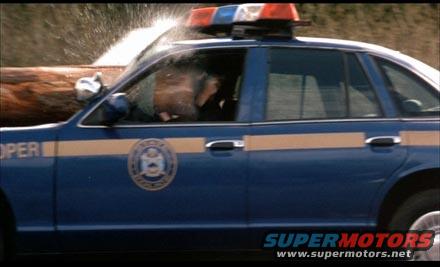 1991 Ford Crown Victoria LTD police car with a log across its windshield