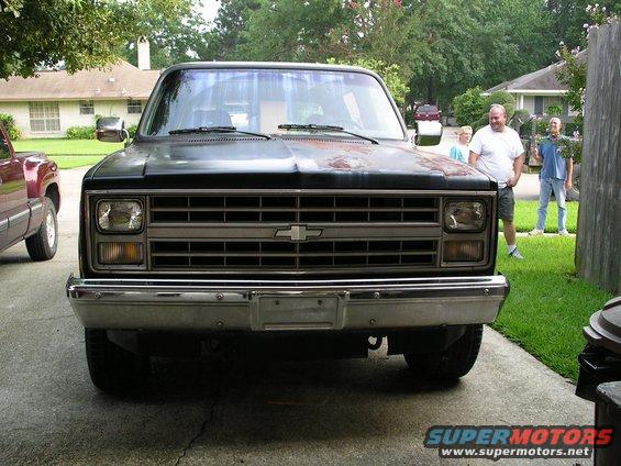 1984 Chevrolet Blazer front view. Another pickup truck is parked to the left