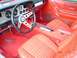 1978 Ford Mustang II - The interior of a 1978 Ford Mustang II features red carpeting and plaid upholstery.