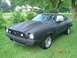 1978 Ford Mustang II - 1978 Ford Mustang II coupe with a custom hood scoop and wheels sits on a grassy lawn.