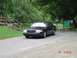 1999 Ford Crown Victoria - A black 1999 Ford Crown Victoria is parked near a park entrance with informational signs.