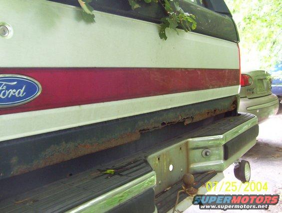 1989 Ford Bronco rear bumper with rust and red stripe on tailgate