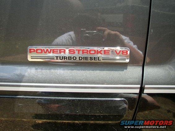 Chrome and red Power Stroke V8 Turbo Diesel badge on a dark gray vehicle door