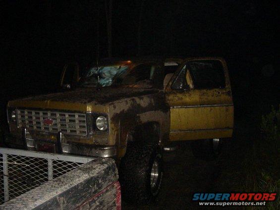 Yellow SUV with open doors, prominent grille, and lifted suspension