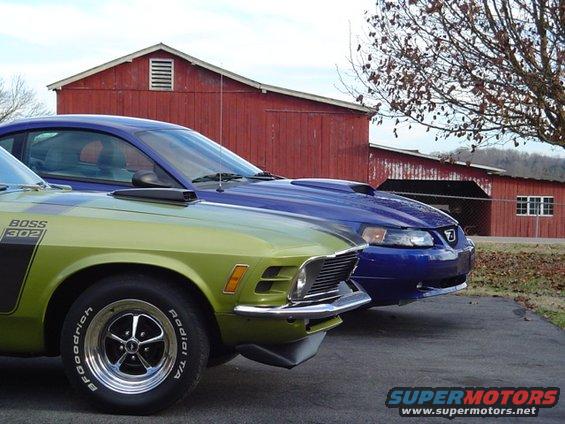 Green 1970 Mustang next to a blue Mustang from a later generation
