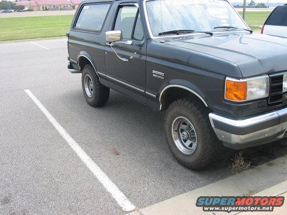 Dark gray 1988 Ford Bronco parked in a lot, showing front quarter panel and side