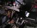 1994 Ford Bronco - Close-up view of engine bay components, including the brake fluid reservoir and a braided hose.
