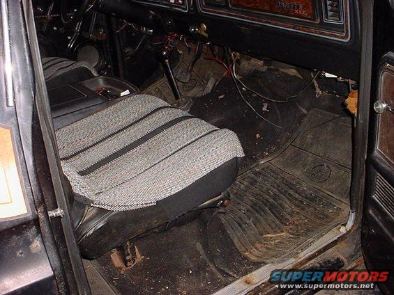 Interior of a 1979 Ford Bronco showing worn seats and floor mats