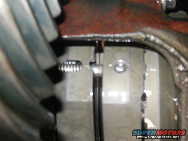 Differential gear teeth and rusty metal housing with visible fluid