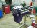 1978 Ford Mustang II - Engine block painted purple sits on a stand in a workshop, with various tools and equipment in the background.