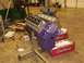 1978 Ford Mustang II - A purple engine is mounted on a stand in a garage, surrounded by parts and tools.