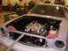 1978 Ford Mustang II - The engine bay of a car, possibly a 1975 model, is shown with the hood open and the engine partially visible.