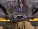 1978 Ford Mustang II - The undercarriage of a vehicle reveals a custom purple transmission and exhaust components.