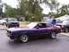 1978 Ford Mustang II - A custom painted coupe with chrome wheels is parked in a lot with other vehicles.