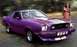 1978 Ford Mustang II - A purple 1977 Ford Mustang II coupe with racing stripes is shown with a woman in a bikini and Supermotors.net logo.