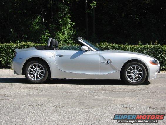 Silver 2003 BMW Z4 convertible parked on asphalt, side view, top down