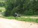 1988 Ford Bronco - This 1988 Ford Bronco navigates a dirt road surrounded by lush greenery.