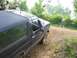 1988 Ford Bronco - A 1988 Ford Bronco navigates a rough dirt path with trees and foliage in the background.