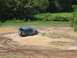 1988 Ford Bronco - This SUV is deep in the mud, with only its top and rear visible above the mire.