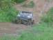 1988 Ford Bronco - This modified Ford Bronco is navigating a challenging off-road trail with steep inclines.