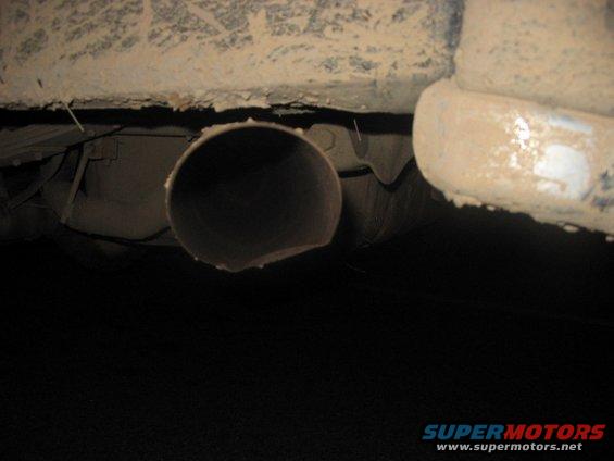 Exhaust pipe and dirty undercarriage of a vehicle