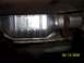 1994 Ford Bronco - Close-up view of a catalytic converter, part of a vehicle's exhaust system.