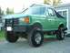 1990 Ford Bronco - This modified Ford Bronco features a lifted suspension and aggressive off-road tires, suggesting a model year prior to 1992.