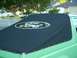 1990 Ford Bronco - Close-up of a black soft top with the Ford logo on a green vehicle.