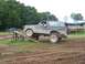 1988 Ford Bronco - Muddy field obstacle course with a 1988 Ford Bronco and another truck.