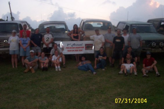 Group of people gathered in front of multiple trucks, with a banner reading '2nd Annual FIT Chapter "Run in the Sun"'. Date stamp shows 07/31/2004