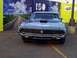 1999 Ford Taurus - A blue 1970 Ford Torino is displayed in front of a Ford 100th anniversary banner.